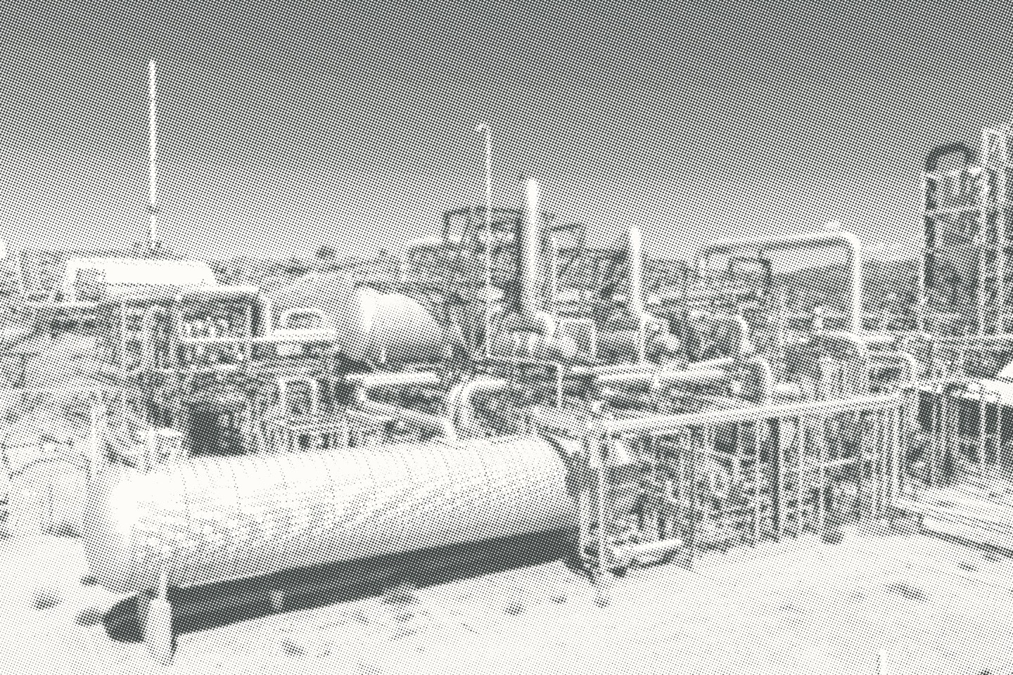 Close view of a process vessel and connected pipework, screened as a halftone.